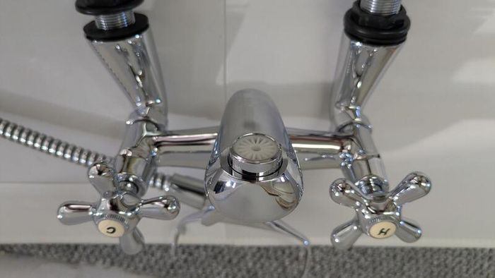 Retro bath mixer with handheld shower head.