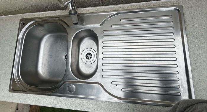 Kitchen sink with countertop and tap