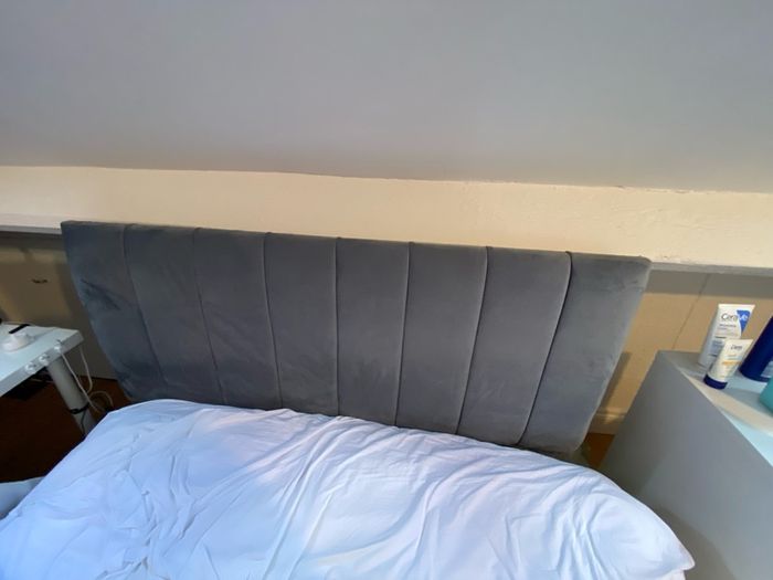 Grey double bed and mattress