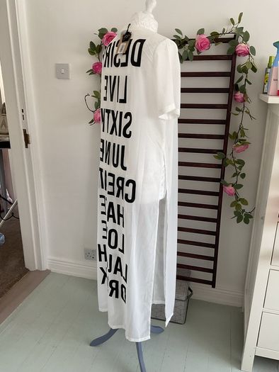 long tunic with side slits Bnwt.  Short sleeve white with black logo