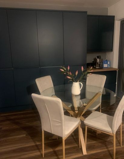 4 beige dining chairs and 2 counter stools