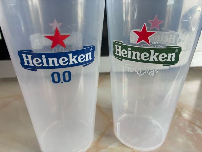 2 plastic Heineken glasses