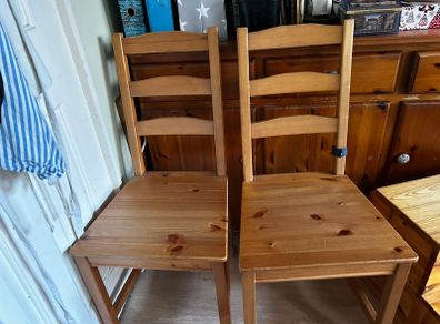 two wooden dining chairs