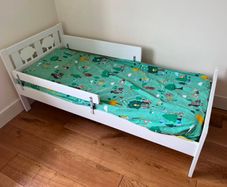 White toddler bed with safety rail