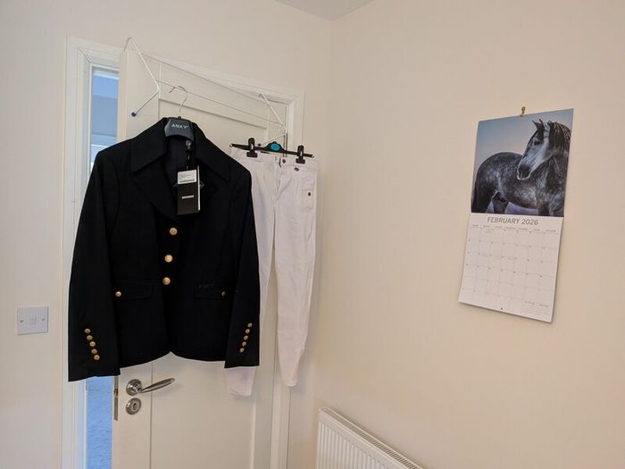 Women's showjumping jacket and jodhpurs