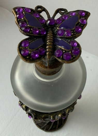Vintage-style frosted glass perfume bottle.