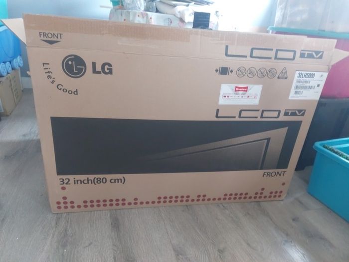 32 inch LG TV with remote and stand in box