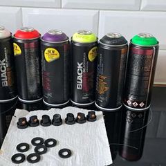 Montana Black fluorescent spray paint cans with assorted caps