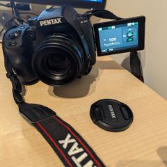 Pentax K-70 digital camera with prime lens and accessories