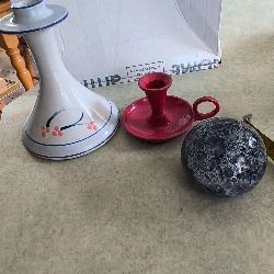 3 different itmes- 1- pottery modern design handmade candle holder 18.00 euro. 2-  red enamel candlestick holder and drip tray featuring a Considered by Helen James 12.00 euro. 3-  PAPERWEIGHT 15.00 euro