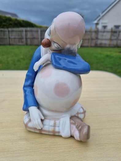 Porcelain sleeping clown with ball