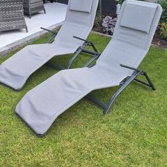 pair of grey reclining garden chairs