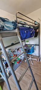 Metal framed loft bed with desk for sale.