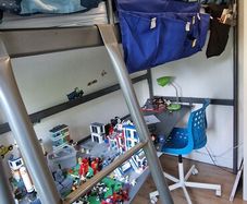 Metal framed loft bed with desk for sale.