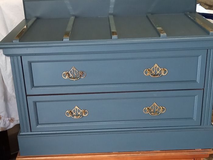 Chest drawers with brass strip suitcase set down