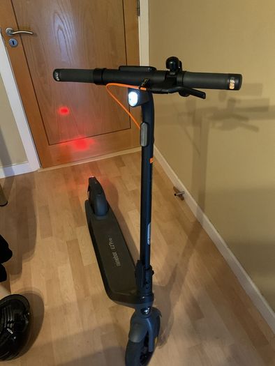 Ninebot E2 scooter with a helmet