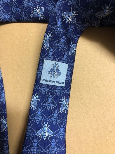 Designer silk tie in blues with bee pattern