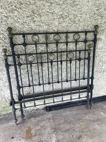 Antique iron bed with brass detail.