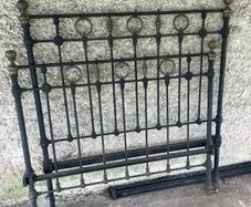 Antique iron bed with brass detail.