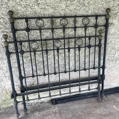 Antique iron bed with brass detail.