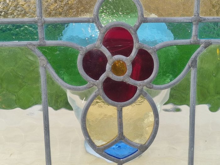 Antique leaded stained-glass panel in the Art Nouveau style.