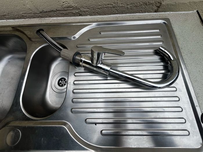 Kitchen sink with countertop and tap