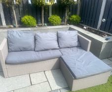 L shaped rattan couch with cushions. In great condition