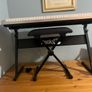 RockJam Electronic Keyboard Piano set up on a sturdy, matching heavy-duty Z-frame stand and an adjustable padded X-frame RockJam Keyboard Bench resting on a wooden surface. Image 8
