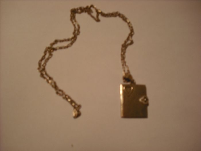 a lovely solid  silver locket and silver chain. in the shape of a book