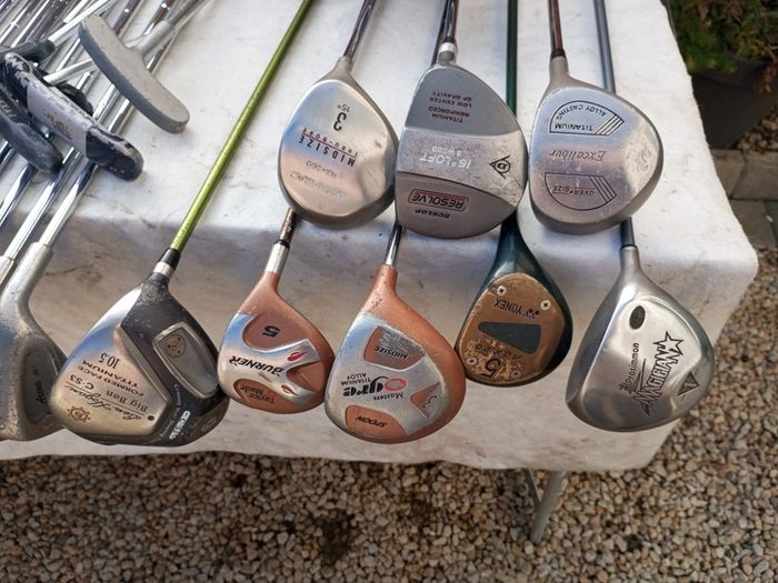 A selection of golf clubs and bags. All right handed clubs.