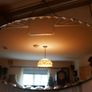 Vintage Art Deco Mirror. Scalloped bevelled edge frameless round wall mirror. Ready to hang on original visible chain. 25" x 15" Image 2