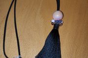 Black cord tassel necklace with a peach tone  large ceramic bead