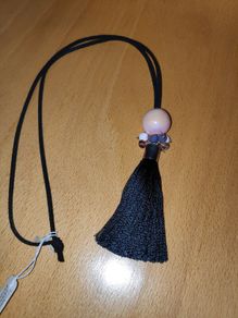 Black cord tassel necklace with a peach tone  large ceramic bead