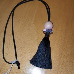 Black cord tassel necklace with a peach tone  large ceramic bead