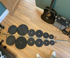 Barbell with 86kg worth of Domyos Weights with clips included.