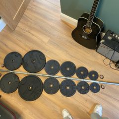 Barbell with 86kg worth of Domyos Weights with clips included.