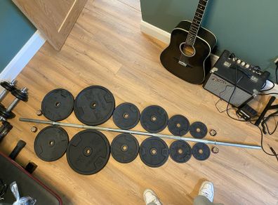 Barbell with 86kg worth of Domyos Weights with clips included.