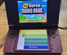 Nintendo DSi XL burgundy with Super Mario