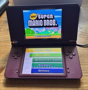 Nintendo DSi XL burgundy with Super Mario