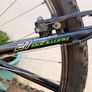 Rockway mountain bike silver and black frame with green accents and a full suspension system. Image 5