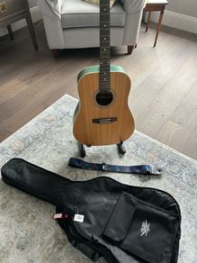 Acoustic guitar with strap, bag, stand and accessories