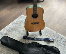 Acoustic guitar with strap, bag, stand and accessories
