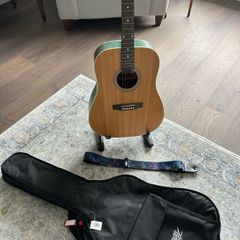 Acoustic guitar with strap, bag, stand and accessories