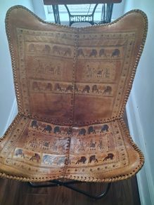 Stunning leather elephant adorned occasional chair