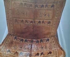 Stunning leather elephant adorned occasional chair