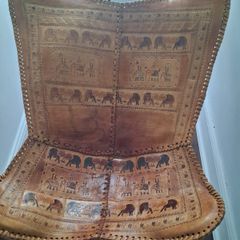 Stunning leather elephant adorned occasional chair