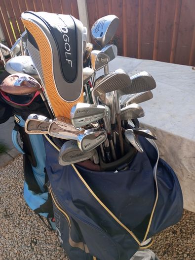 A selection of golf clubs and bags. All right handed clubs.