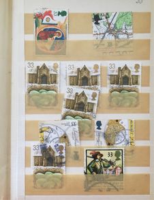 Small brown stamp stock book. 13cm x 18.5cm. 24 page / 12 leaf. Album contains used England Stamps with values over 29p