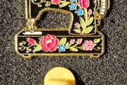 Sewing machine, pin back badge.