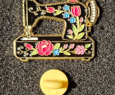 Sewing machine, pin back badge.
